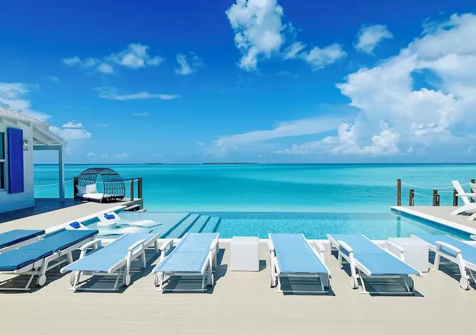 An infinity pool meeting a turquoise ocean horizon